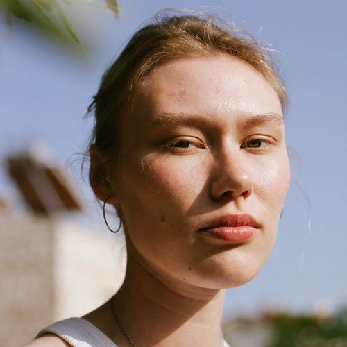 Portrait of a smiling woman in a casual setting.